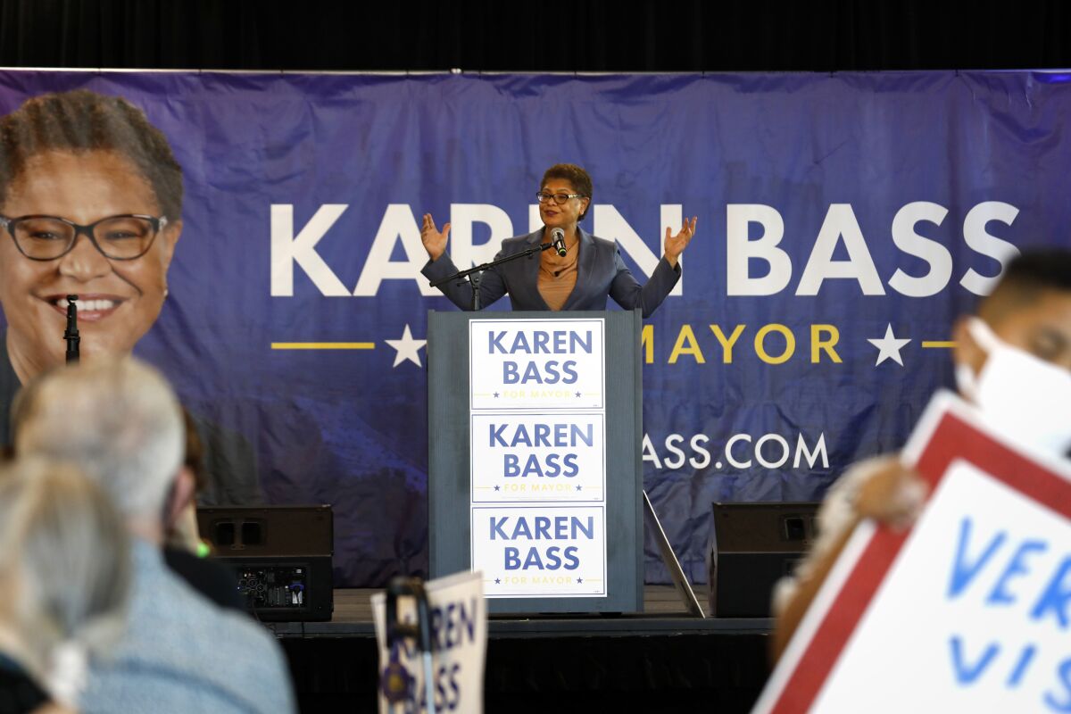 Karen Bass surrounded by signs supporting her for mayor.