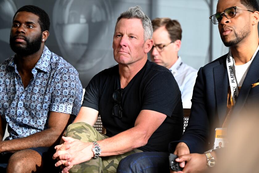Lance Armstrong, center, and others listen to a panel discussion during SXSW on March 11 in Austin, Texas.