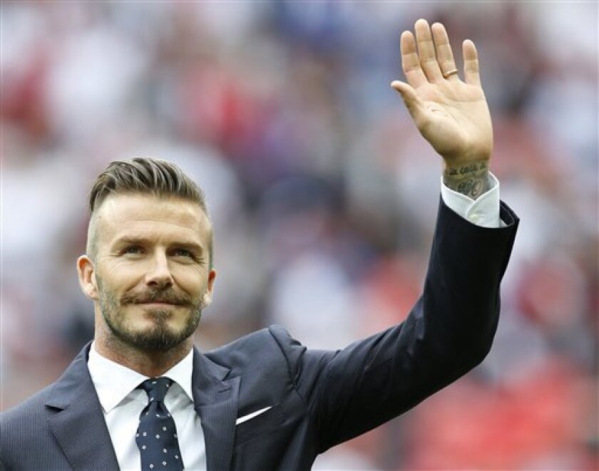 FILE This Saturday, June 2, 2012 file photo shows England's David Beckham in a special half-time ceremony to honor the five players that have played for England over 100 times each during the international friendly soccer match between England and Belgium at Wembley Stadium in London. Former England captain David Beckham has failed to make the British football team for the London Olympics. The Los Angeles Galaxy midfielder made Britain coach Stuart Pearce's shortlist of 35 but wasn't selected for the final 18-man squad as one of three players over the age of 23 allowed to compete in the games. "Everyone knows how much playing for my country has always meant to me, so I would have been honored to have been part of this unique Team GB squad," the 37-year-old Beckham said Thursday June 28, 2012 in a statement to The Associated Press.(AP Photo/Kirsty Wigglesworth)