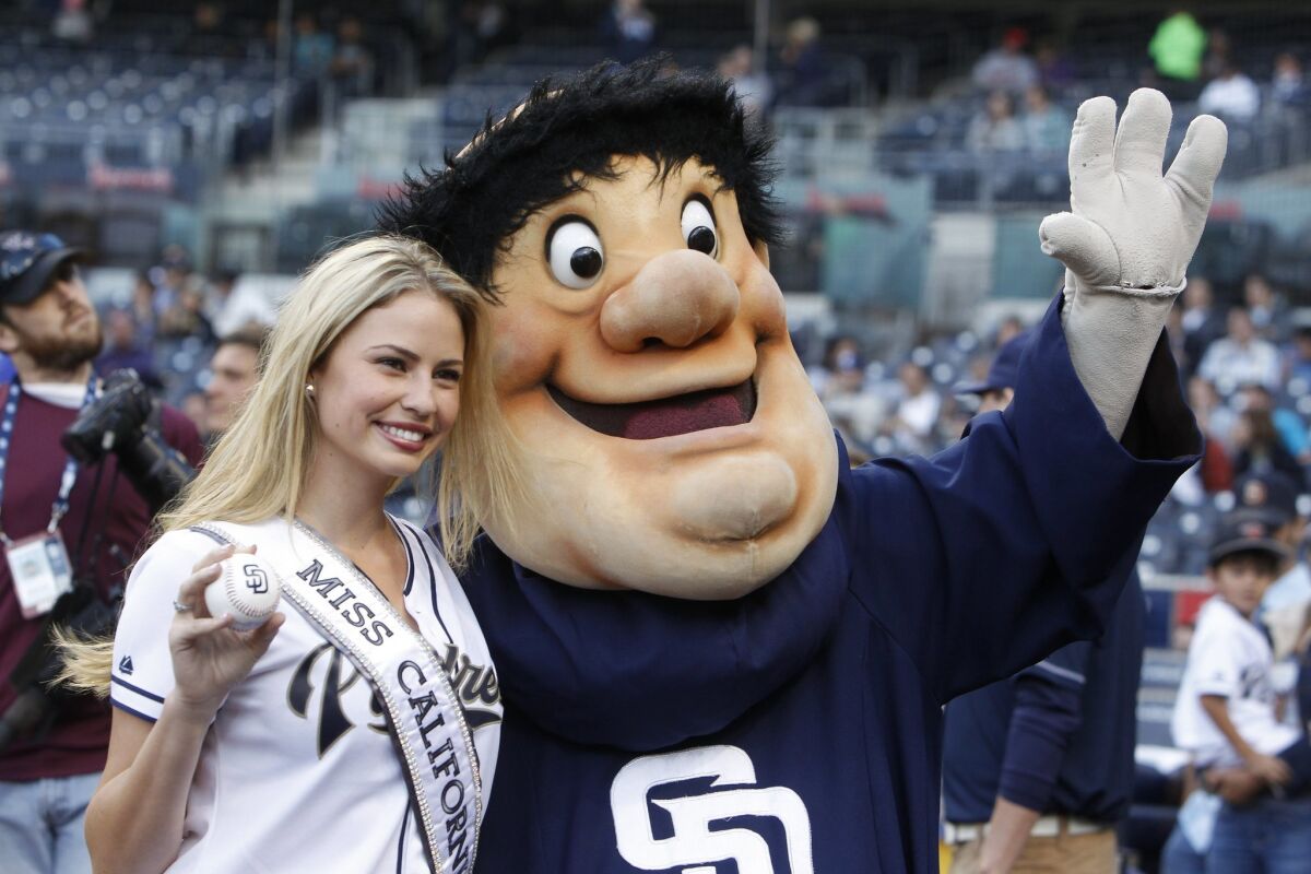 Miss California 2014 and San Diego local Cassandra Kunze poses with the Padres' mascot, the Swingin' Friar, before the start of the Padres game against the Minnesota Twins.