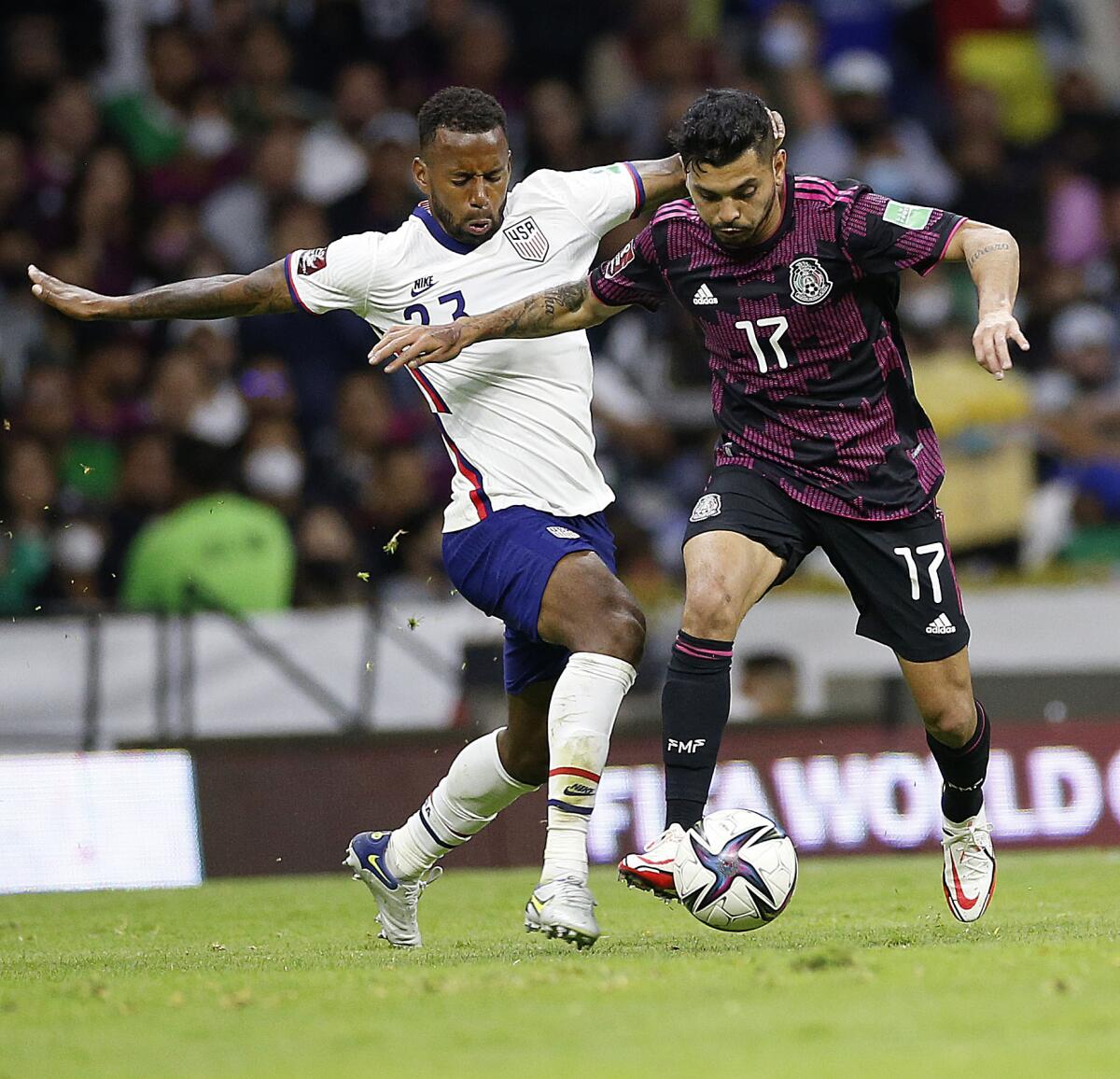 U.S. midfielder Kellyn Acosta, left, and Mexico forward Jesus Corona vie for the ball in a match last month.