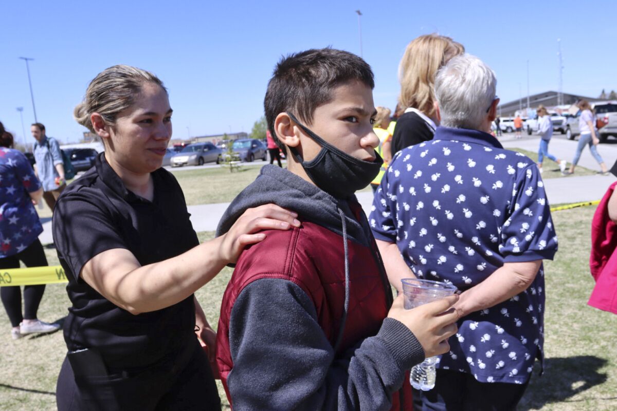 Alela Rodriguez, left, walks with her son, Yandel Rodriguez, 12, at the high school where people were evacuated after a shooting at the nearby Rigby Middle School earlier Thursday, May 6, 2021, in Rigby, Idaho. Authorities said that two students and a custodian were injured, and a male student has been taken into custody. (AP Photo/Natalie Behring)