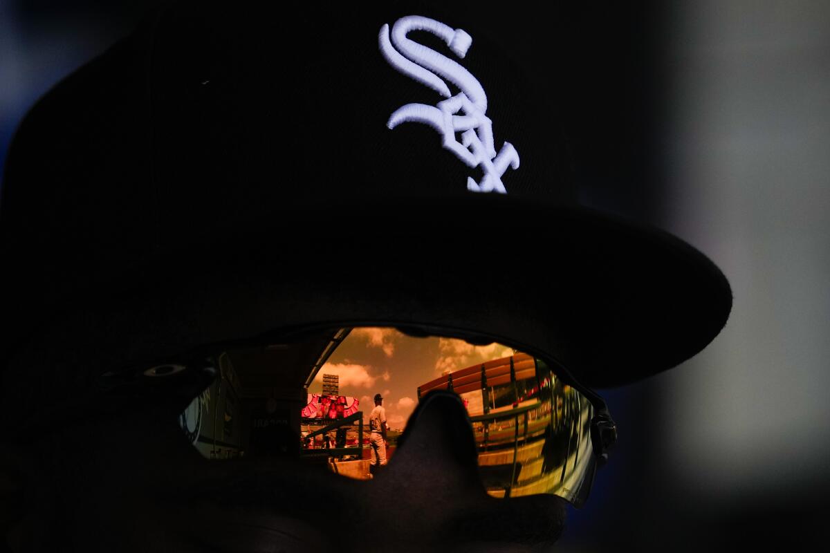 Chicago White Sox first base coach/outfield coach Jason Bourgeois (38) is reflected in the glasses.