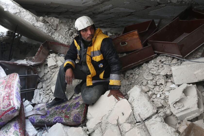 Forty-five-year-old Samir Salim (L), who along with his three brothers are members of the White Helmets rescue forces, sits in the rubble of his home in the town of Medeira in Syria's rebel-held Eastern Ghouta area on February 12, 2018. For years, Samir Salim and his brothers rescued neighbours and relatives pinned underground after bombardment on Syria's rebel-held Eastern Ghouta. But last week, they could not save their own mother. / AFP PHOTO / ABDULMONAM EASSAABDULMONAM EASSA/AFP/Getty Images ** OUTS - ELSENT, FPG, CM - OUTS * NM, PH, VA if sourced by CT, LA or MoD **