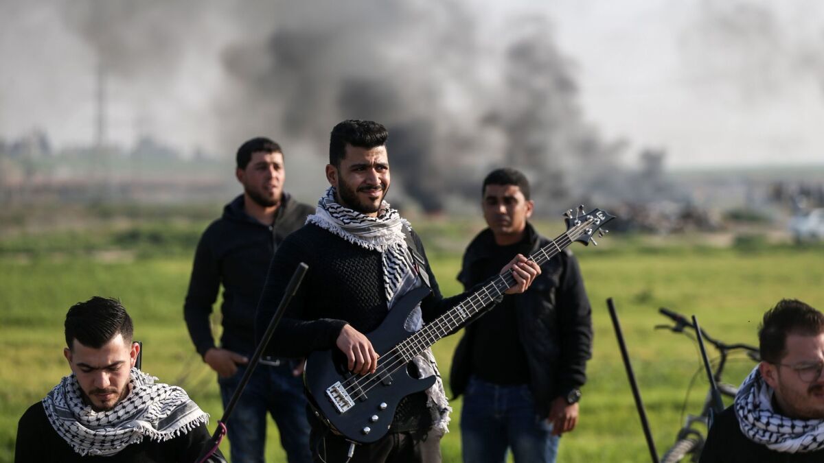 A Palestinian band performs a concert during clashes near the border with Israel, east of Gaza City, on Feb. 2, 2018.