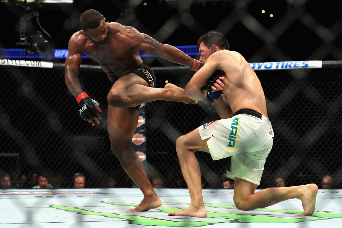 Tyron Woodley tries to fight off a takedown attempt by Demian Maia during their Wwlterweight title bout during UFC 214.