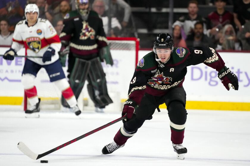 Arizona Coyotes right wing Clayton Keller skates with the puck before scoring an empty-net goal against the Florida Panthers during the third period of an NHL hockey game in Tempe, Ariz., Tuesday, Nov. 1, 2022. The Coyotes won 3-1. (AP Photo/Ross D. Franklin)