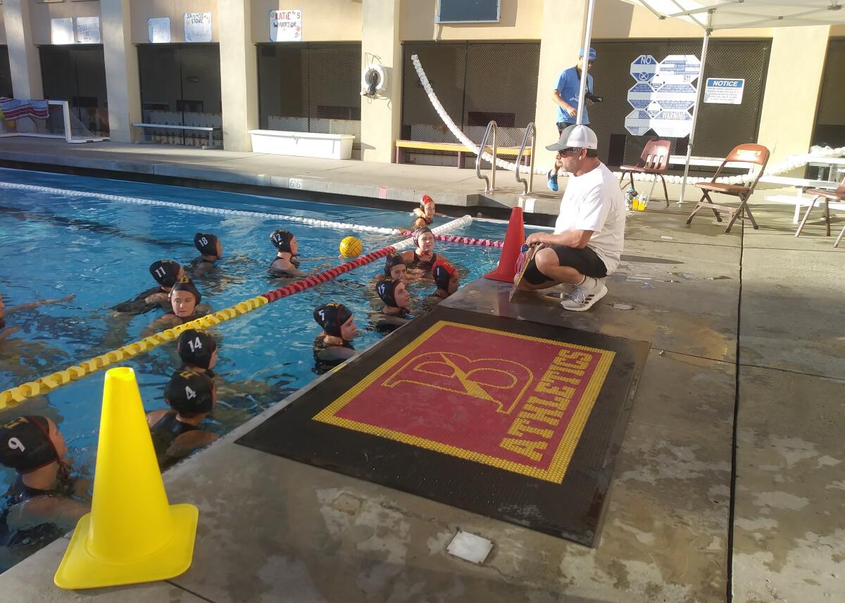 Bishop’s coach Doug Peabody instructs the Knights ahead of their 17-2 victory over Del Norte for the San Diego Open girls water polo tournament title in the elite Odin Division on Saturday, Feb. 1.