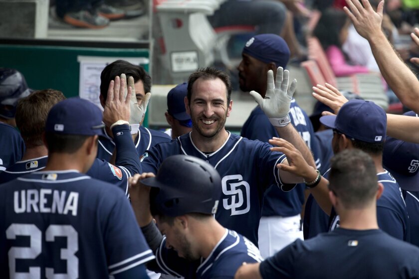 San Diego Padres' infielder Adam Rosales is greeted by teammates after batting during a spring training baseball game with the Houston Astros in Mexico City, Sunday, March 27, 2016. (AP Photo/Eduardo Verdugo)