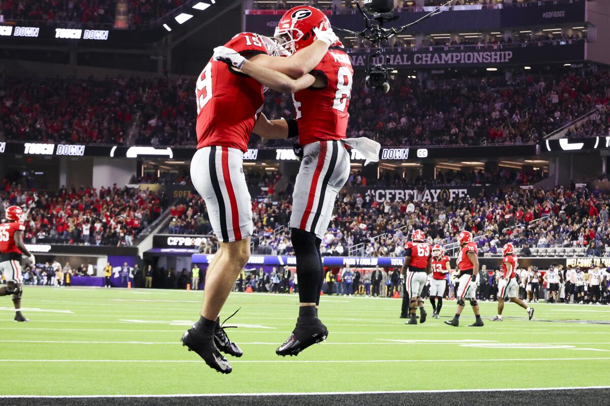 Georgia wide receiver Ladd McConkey (84) celebrates his second touchdown catch with tight end Brock Bowers.