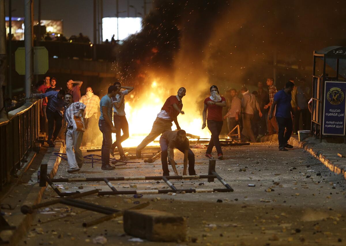 Supporters of Egypt's ousted president, Mohamed Morsi, throw stones at opponents and security forces during clashes in Cairo.
