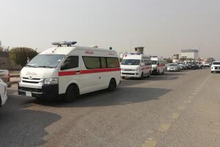 Ambulances line up in front of a headquarters of the Popular Mobilization Force after it was hit by an airstrike in Baghdad, Iraq, Thursday, Jan. 4, 2024. The Popular Mobilization Force - a coalition of militias that is nominally under the control of the Iraqi military - announced in a statement that its deputy head of operations in Baghdad, Mushtaq Taleb al-Saidi, or "Abu Taqwa," had been killed in the strike. (AP Photo/Hadi Mizban)