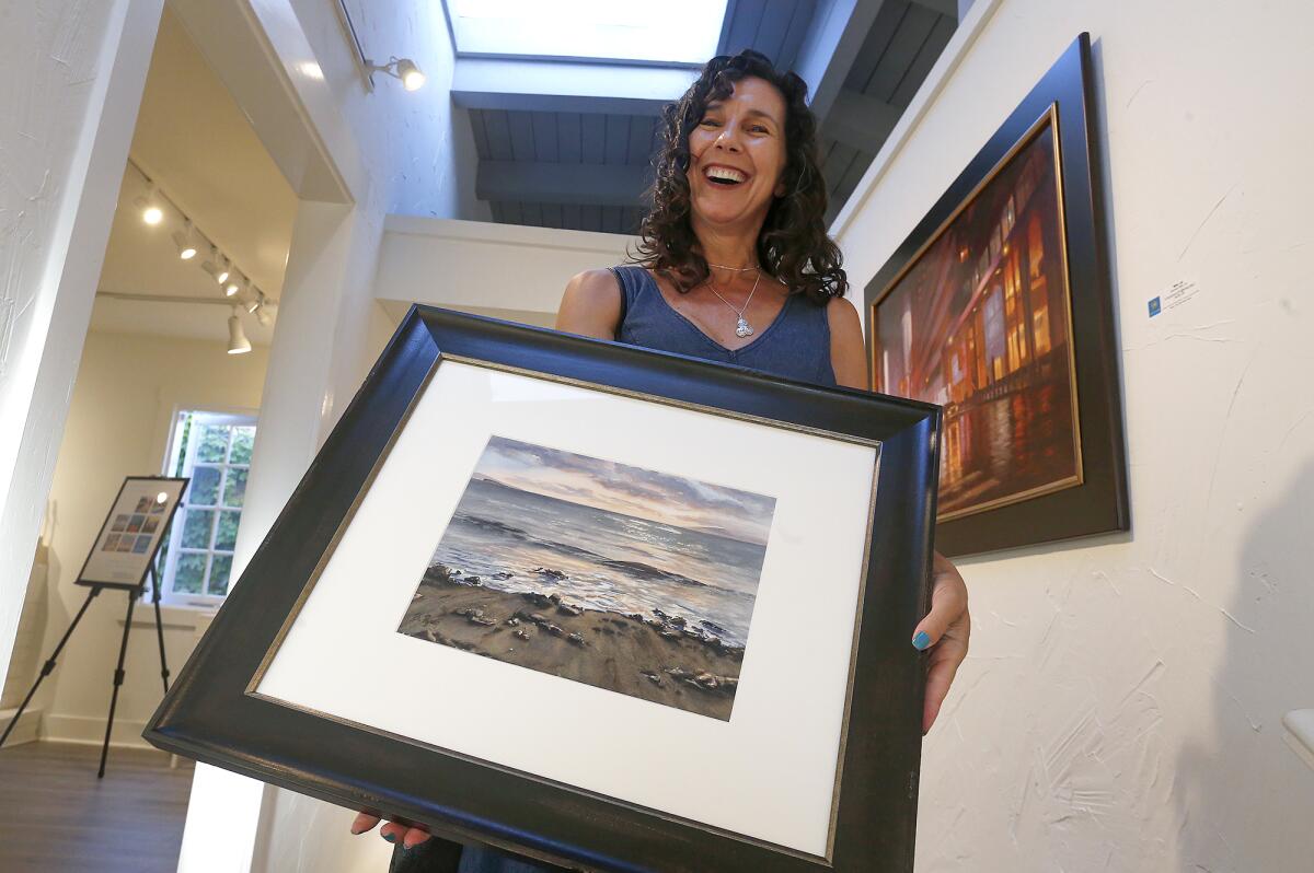Artist Becky Ryan, with her piece "Sunset on the Rocks."