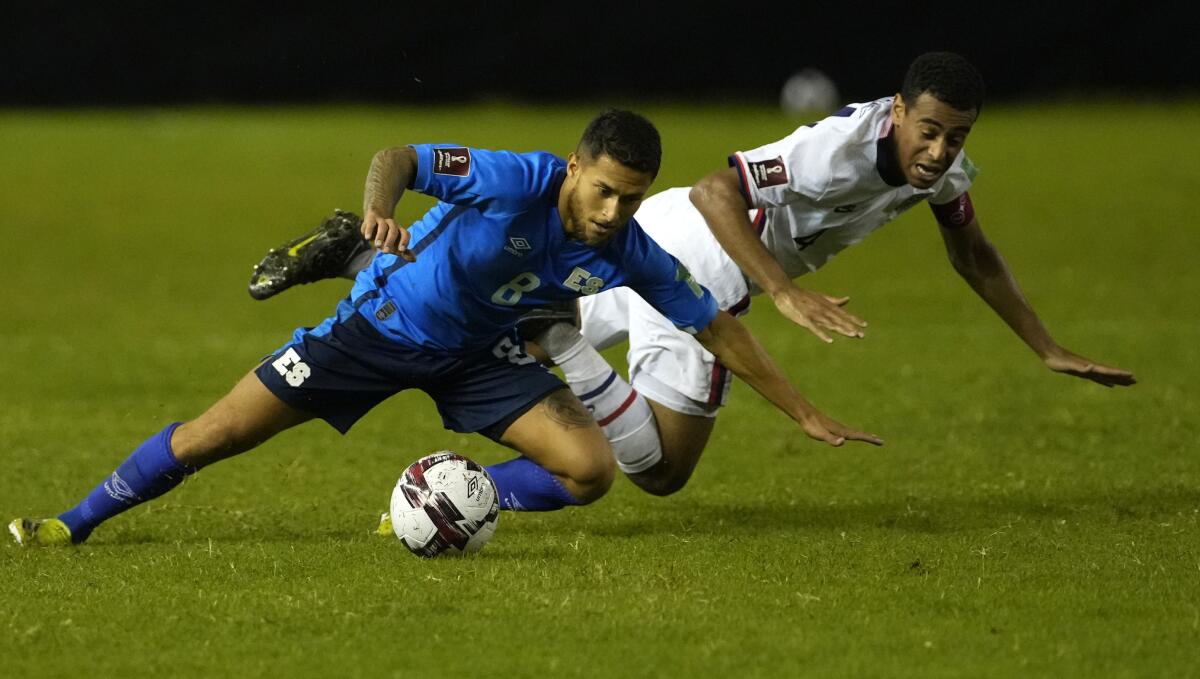 El Salvador's Joshua Perez and United States' Tyler Adams fight for the ball.