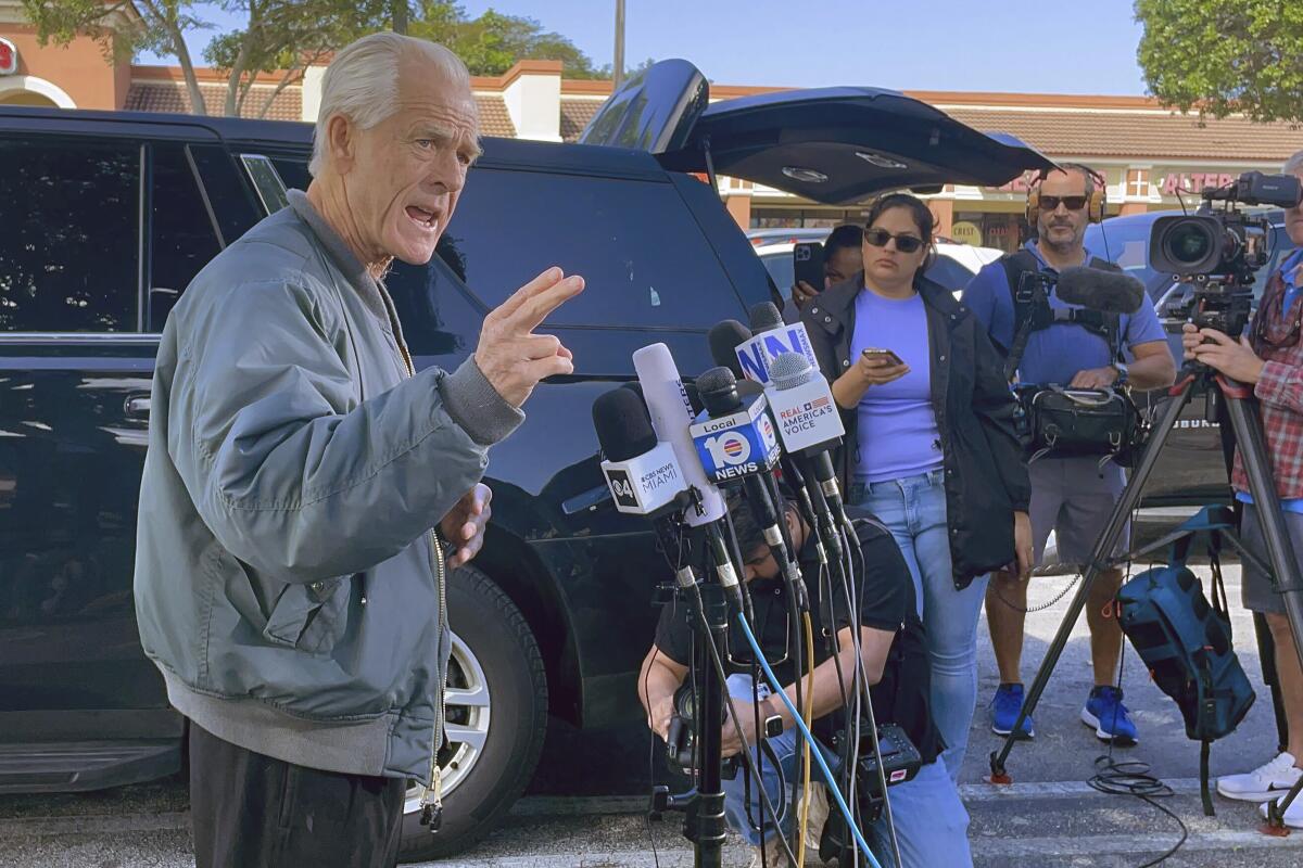 Former Trump White House official Peter Navarro speaks to reporters.
