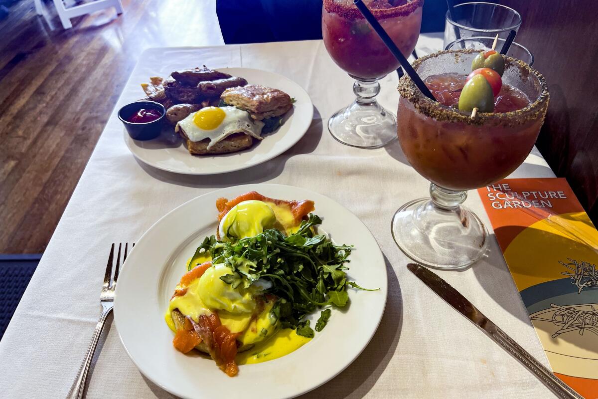Smoked salmon benedict and buttermilk biscuit breakfast sandwich with a bloody mary and a bacon bloody mary