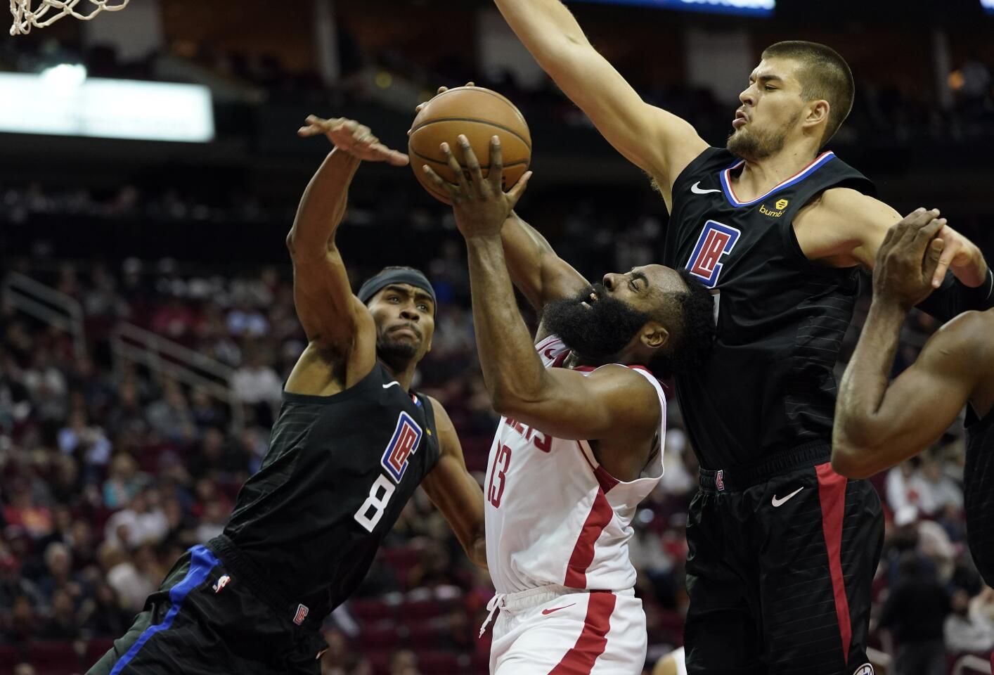Rockets guard James Harden (13) goes up for a shot against Clippers Maurice Harkless (8) and Ivica Zubac during the second half of a game Nov. 13.
