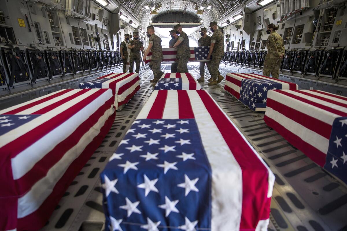U.S. Marines and sailors carry a casket in Miramar, Calif.