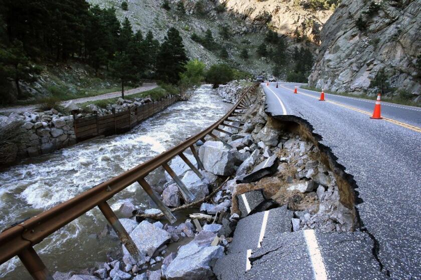 A guardrail hangs away from a flood-damaged canyon road, which links Boulder with the mountain town of Nederland.