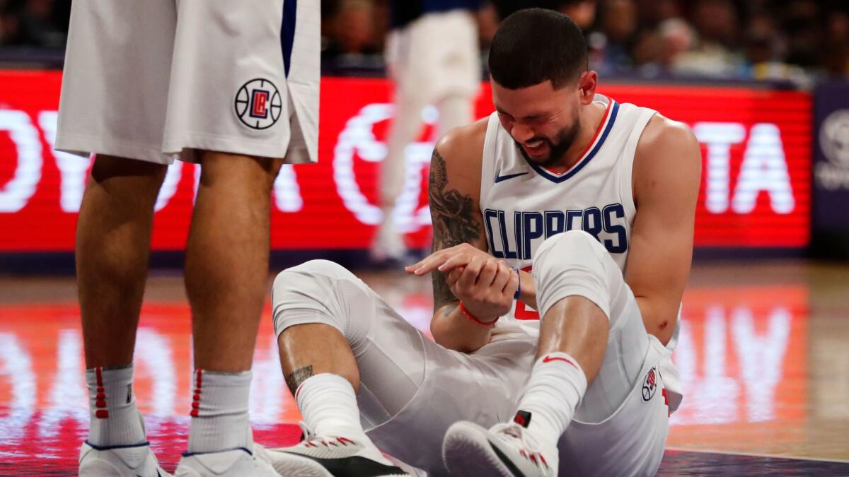 Clippers guard Austin Rivers (25) reacts in pain after injuring his left hand against the Lakers in the first half at Staples Center on Dec. 29, 2017.