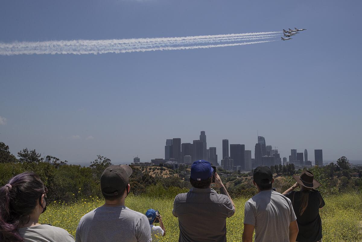 The U.S. Air Force's Thunderbirds fly in formation over the downtown Los Angeles skyline, as seen from Angel's Point in Elysian Park.