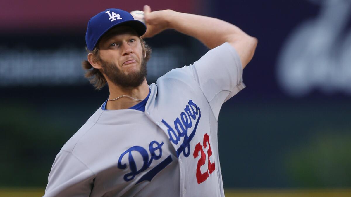 Dodgers starter Clayton Kershaw delivers a pitch during the first inning of the Dodgers' 6-1 win over the Colorado Rockies in a rain-shortened game Sunday.