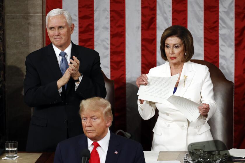 House Speaker Nancy Pelosi of Calif., tears her copy of President Donald Trump's s State of the Union address after he delivered it to a joint session of Congress on Capitol Hill in Washington, Tuesday, Feb. 4, 2020. Vice President Mike Pence is at left. (AP Photo/Patrick Semansky)