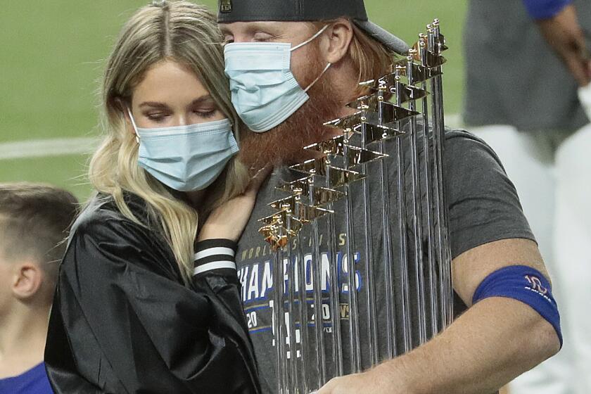 Justin Turner holds the trophy after the Dodgers won the World Series in Arlington, Texas, on Oct. 27, 2020.