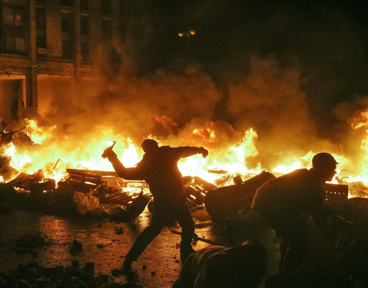 Protesters clash with riot police at Independence Square in downtown Kiev, Ukraine, on Tuesday.