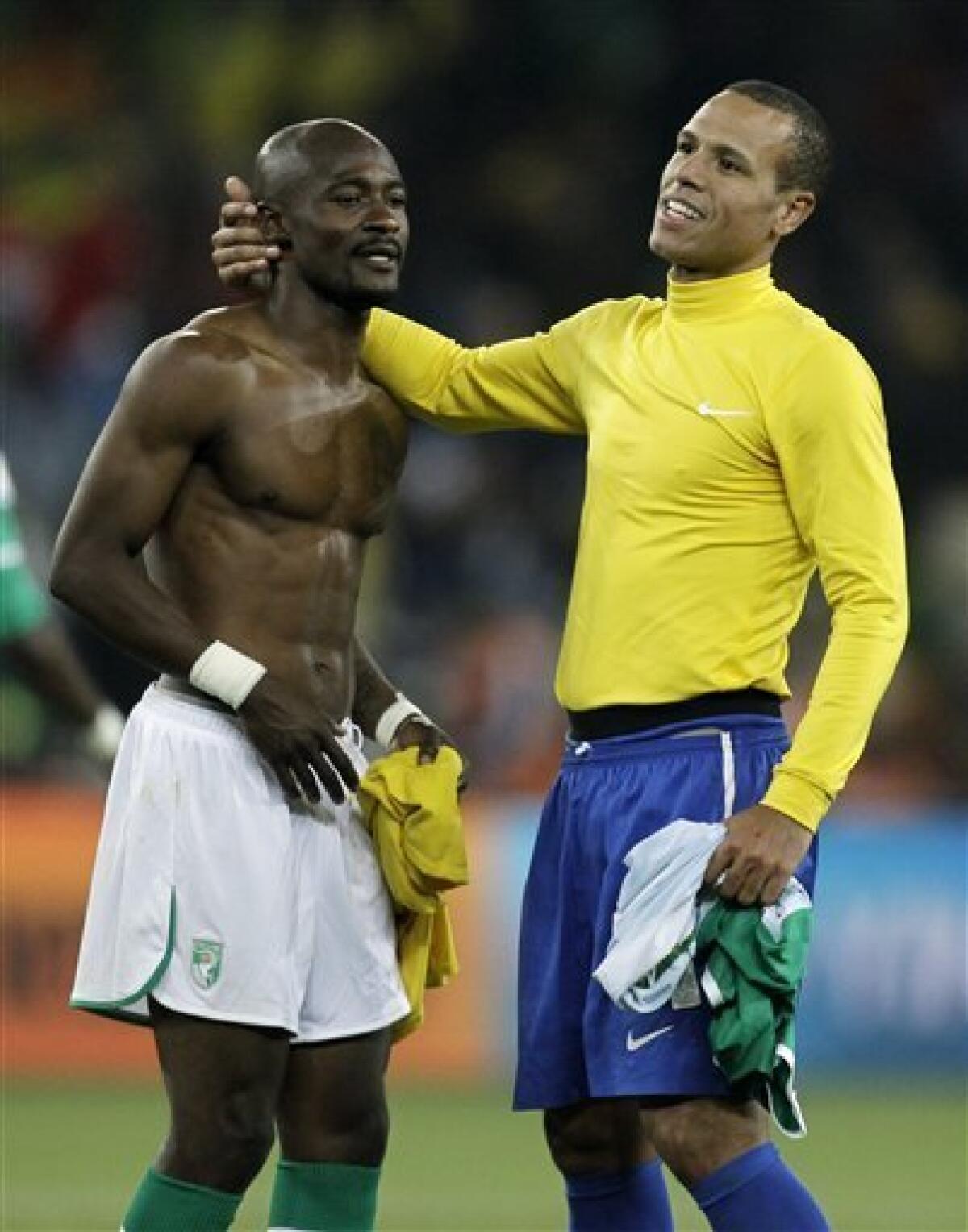 Ivory Coast's Didier Zokora, left, and Brazil's Luis Fabiano, right, embrace at the end of the World Cup group G soccer match between Brazil and Ivory Coast at Soccer City in Johannesburg, South Africa, Sunday, June 20, 2010. (AP Photo/Matt Dunham)