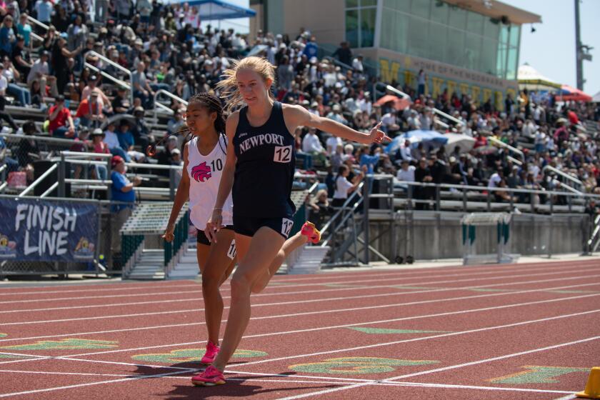 Newport Harbor's Keaton Robar crosses the finish line first in the 800 meters.