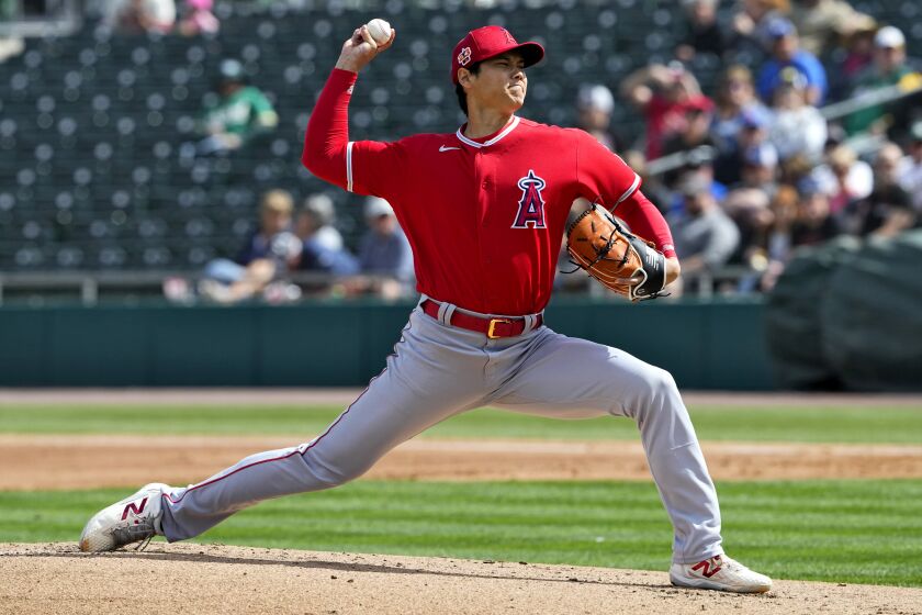 Los Angeles Angels starting pitcher Shohei Ohtani (17) throws against the Oakland Athletics during the first inning of a spring training baseball game, Tuesday, Feb. 28, 2023, in Mesa, Ariz. (AP Photo/Matt York)