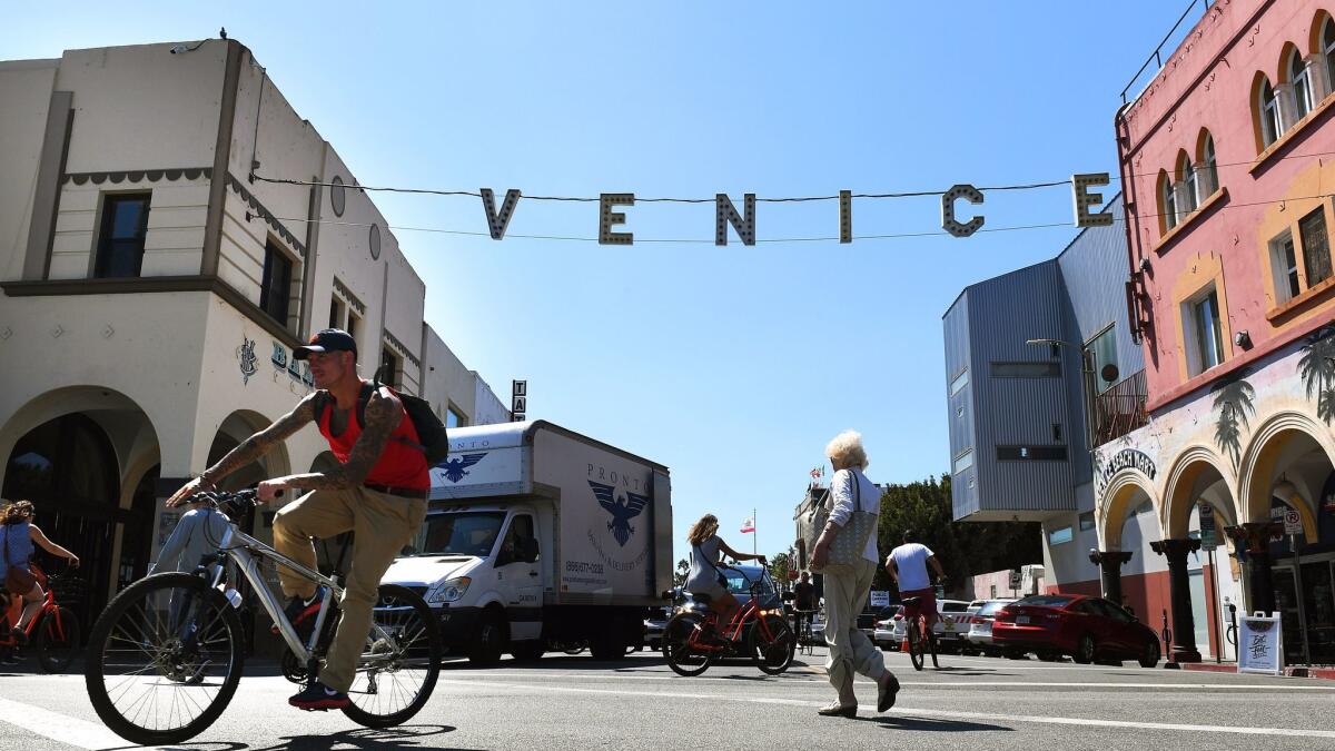 A pedestrian was killed crossing a busy street in Venice Beach Wednesday. Above, bicyclists and pedestrians move through a busy intersection not far from the site of the crash.