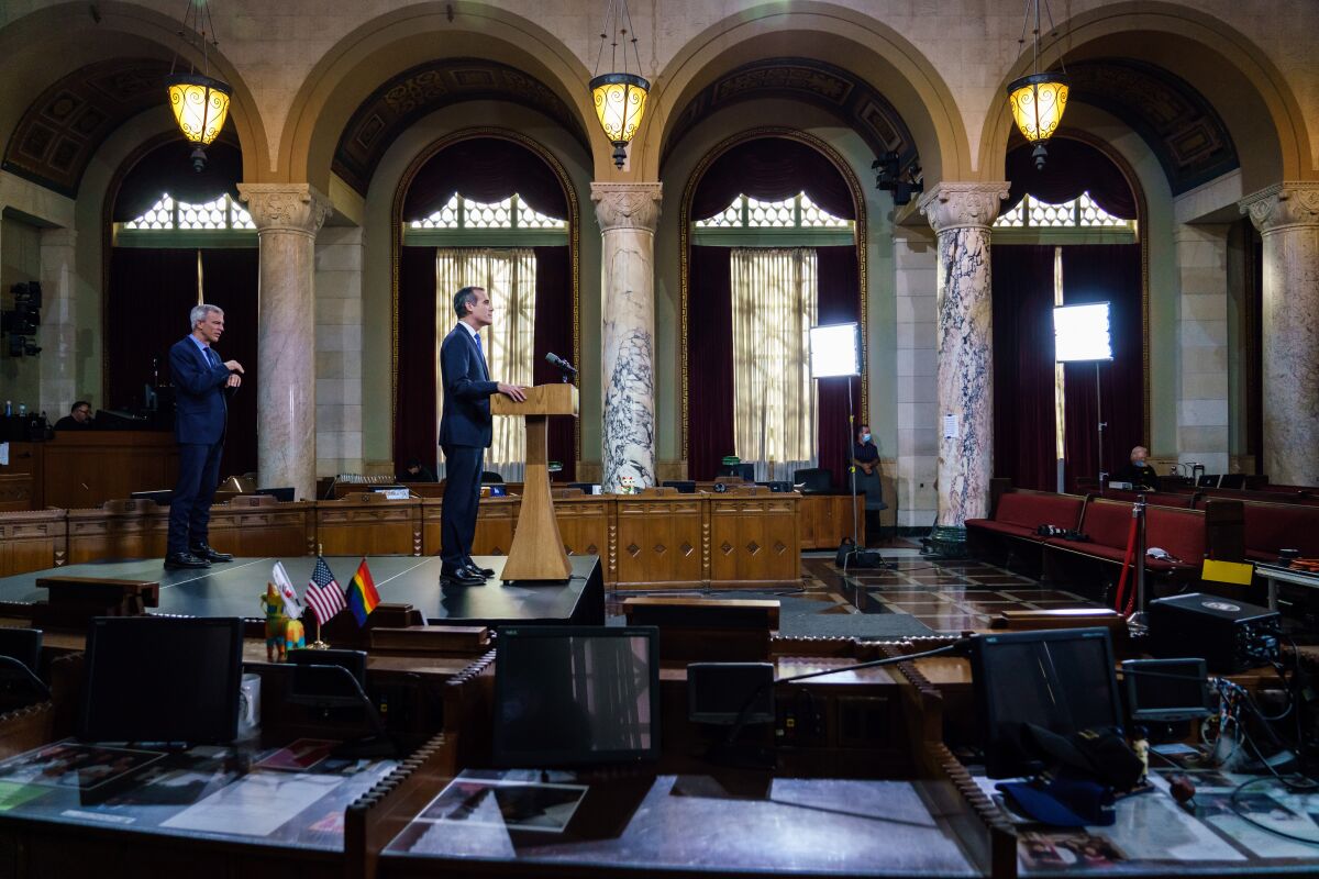 Los Angeles Mayor Eric Garcetti gives his annual "State of the City'" on Sunday night before a largely empty City Council chamber.