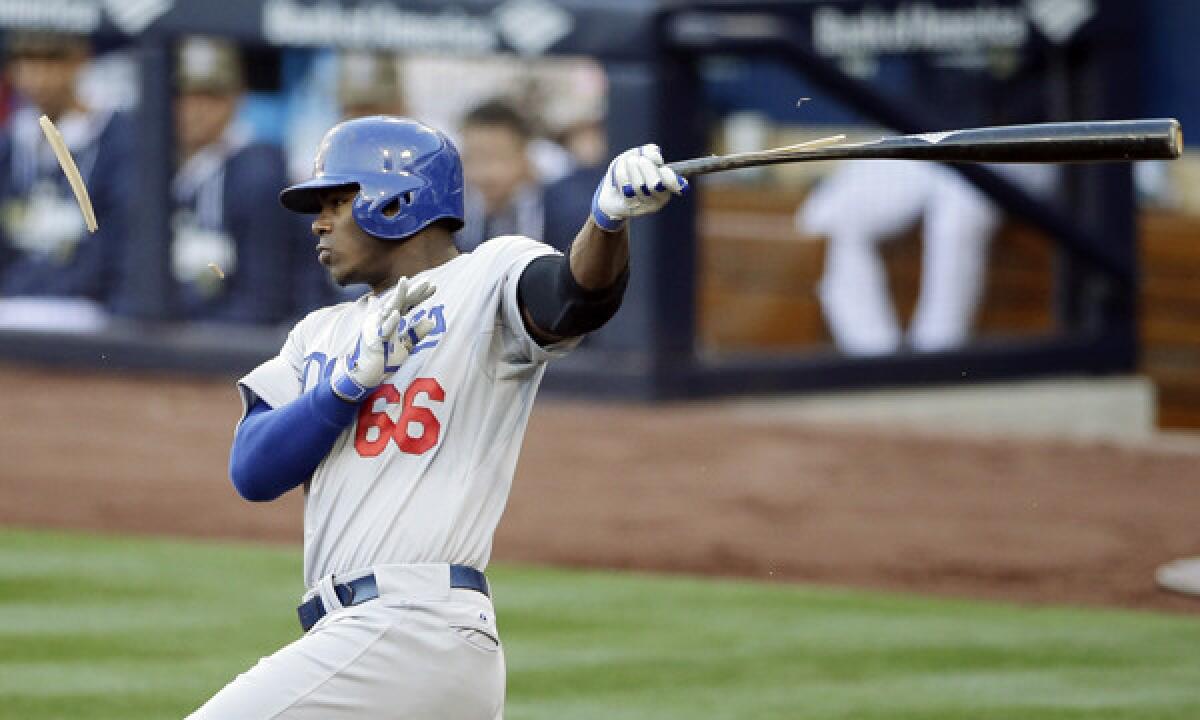 Dodgers outfielder Yasiel Puig breaks his bat while grounding out during the third inning of the Dodgers' 3-1 loss to the San Diego Padres on Sunday.