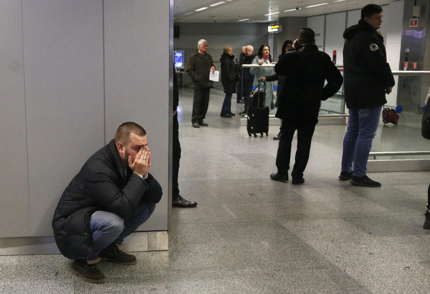 A relative of a flight stewardess on the ill-fated Ukraine-bound flight reacts to the news at an airport outside Kyiv, Ukraine, on Wednesday.
