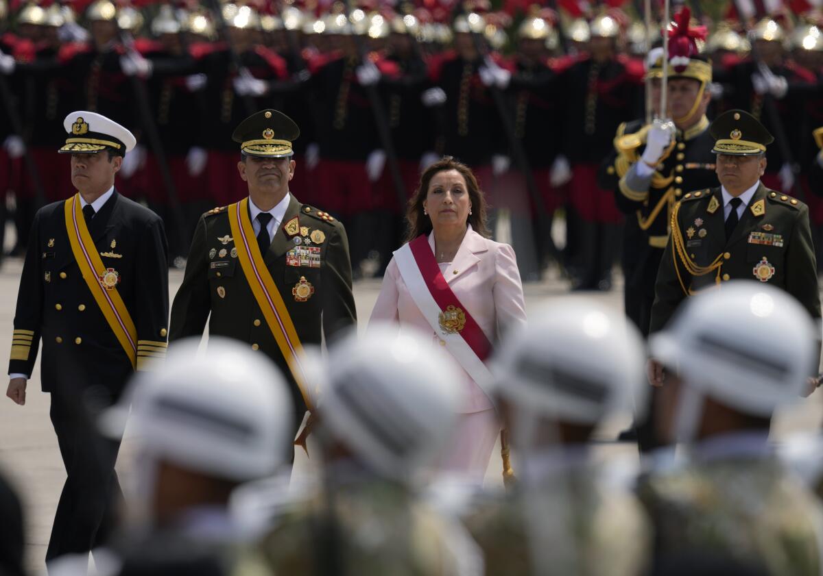 Peru's new President Dina Boluarte attends a ceremony marking Amy Day in Lima, Peru, Friday, Dec. 9, 2022. Peru's Congress voted to remove President Pedro Castillo from office Wednesday and replace him with the vice president, Boluarte, shortly after Castillo tried to dissolve the legislature ahead of a scheduled vote to remove him. (AP Photo/Martin Mejia)