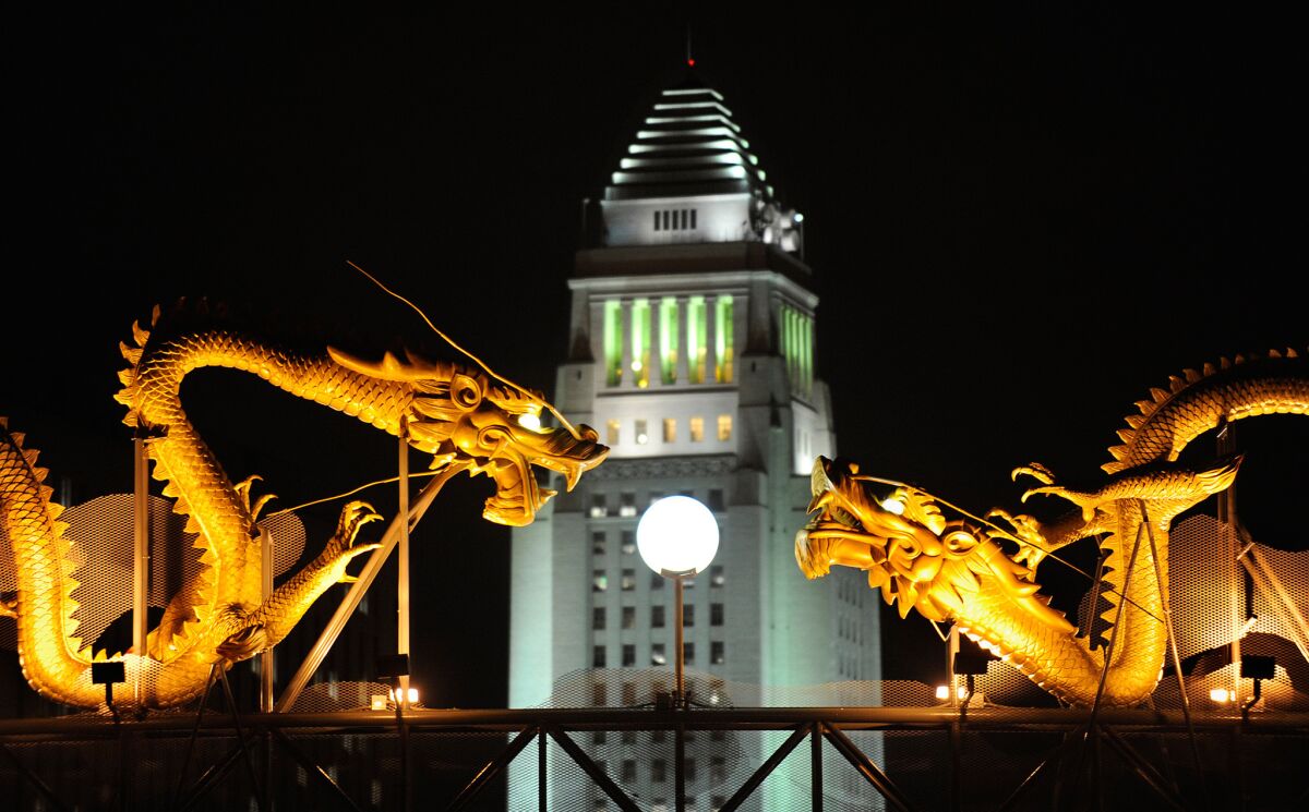 Los Angeles City Hall is bordered by statues of dragons in a view from Chinatown. 