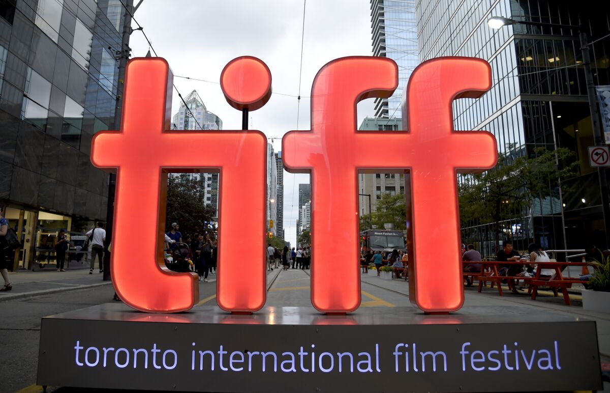 FILE - In this Thursday, Sept. 6, 2018, file photo, a view of a festival sign appears on Day 1 of the Toronto International Film Festival in Toronto. Organizers announced Tuesday, July 20, 2021, that among the films that premiere at this year’s TIFF will be the adaptation of the Tony-winner “Dear Evan Hansen,” which will open the festival, Edgar Wright’s ’60s London themed “Last Night in Soho,” and “The Eyes of Tammy Faye.” TIFF runs Sept. 9-18. (Photo by Chris Pizzello/Invision/AP, File)