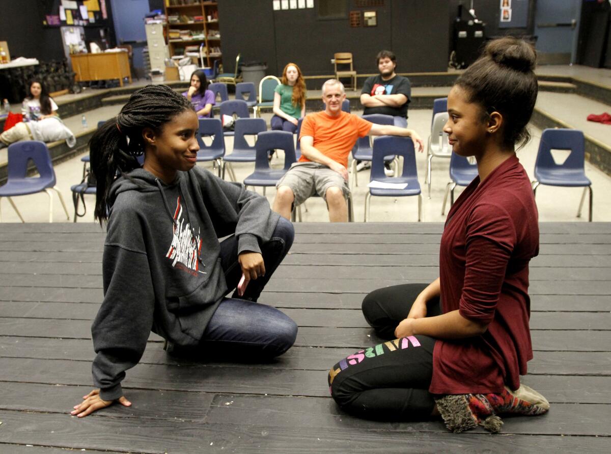 Hoover High School 9th grader Vivica Rush, left, and 10th grader Sabrina Taylor, right, perform at the school's drama room in the 18th hour of a 24-hour improv marathon on Saturday, Nov. 16, 2013. Drama teacher Dave Huber oversees the acting at background center.