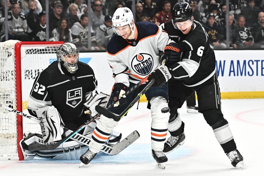 Los Angeles, California May 12, 2022-Kings Olli Maatta defends against Oilers Zach Hyman as goalie Jonathan Quick makes a save in the second period in game six of the first round playoffs at Crypto.com Arena Thursday. (Wally Skalij/Los Angeles Times)