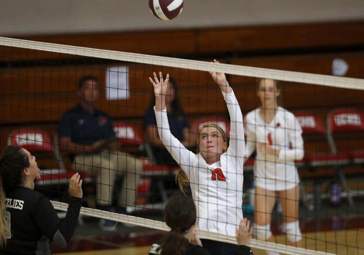Allyson Scharrer of Pacifica Christian Orange County sets the ball over the net at Downey Calvary Chapel in the first set of a nonleague match on the road Tuesday.