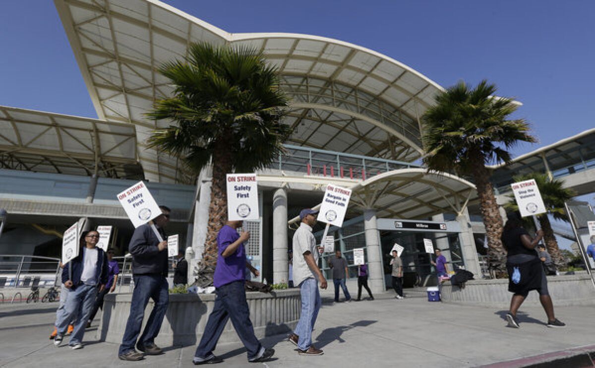 Bay Area Rapid Transit workers picket outside of a station in Millbrae, Calif.