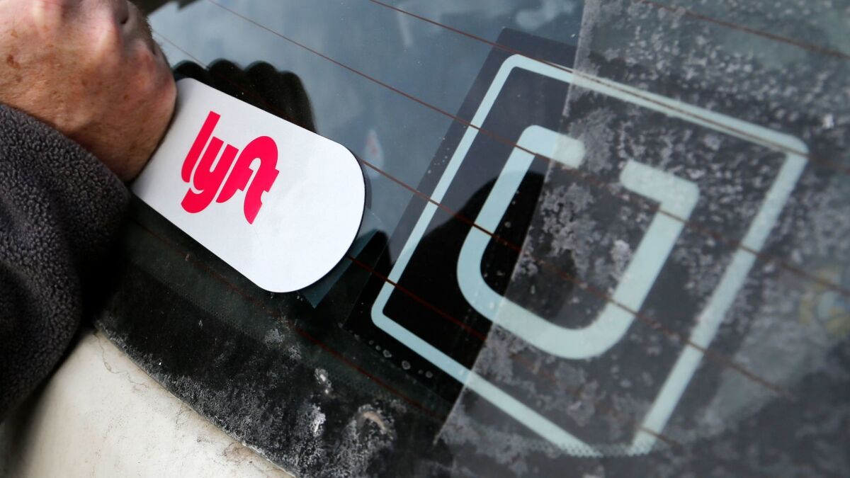 A Lyft logo is installed on a driver's car in Pittsburgh.