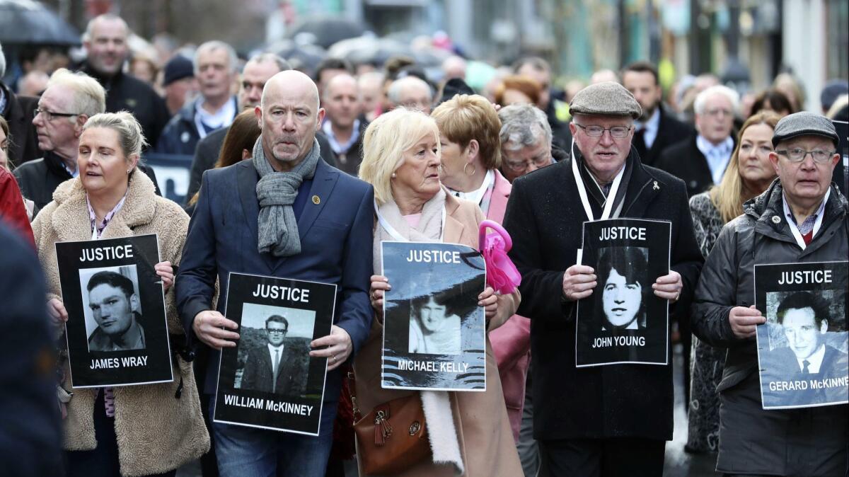 Families hold photographs of the victims of Bloody Sunday and march in Northern Ireland. A former British soldier is set to be prosecuted in connection with the deaths of two civil rights protesters in Northern Ireland more than 40 years ago.