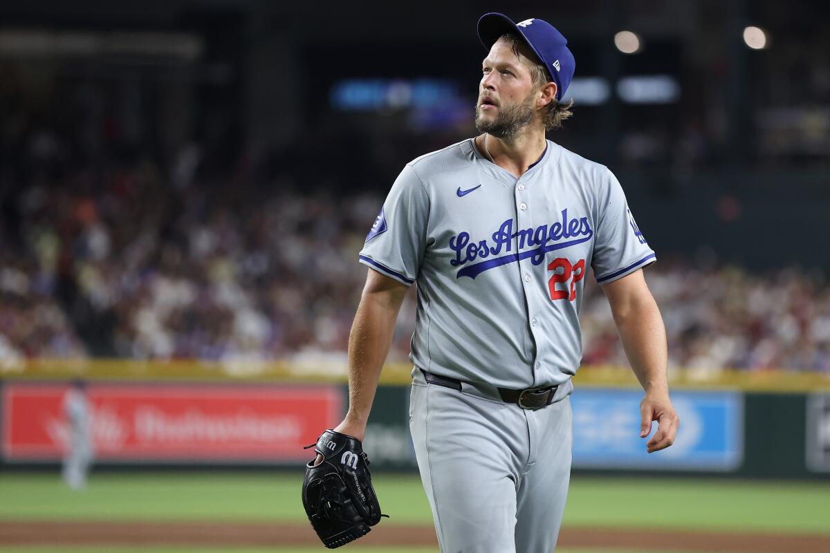 Dodgers pitcher Clayton Kershaw walks toward the dugout after giving up a home run.