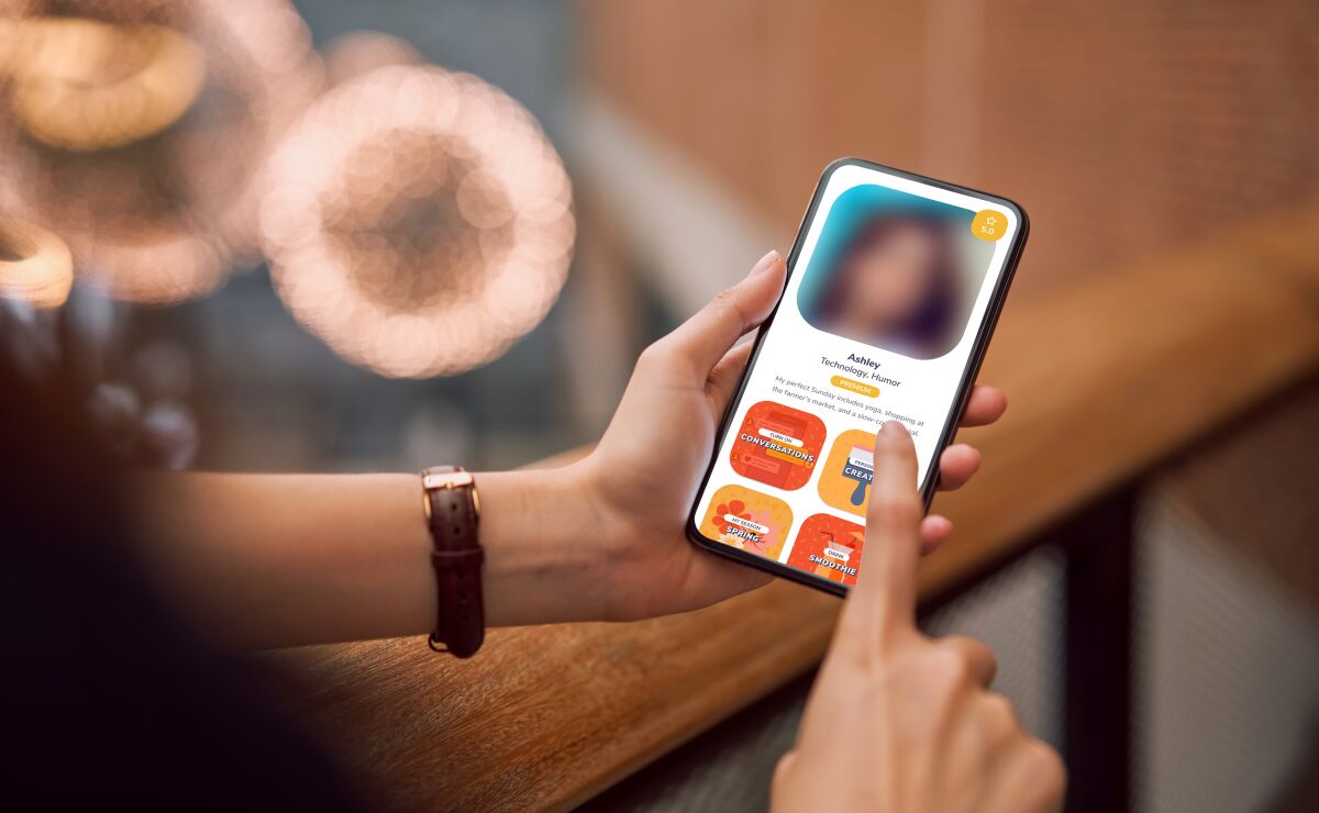 Rendering of the S'More dating app on a smartphone with the profile photo blurred.