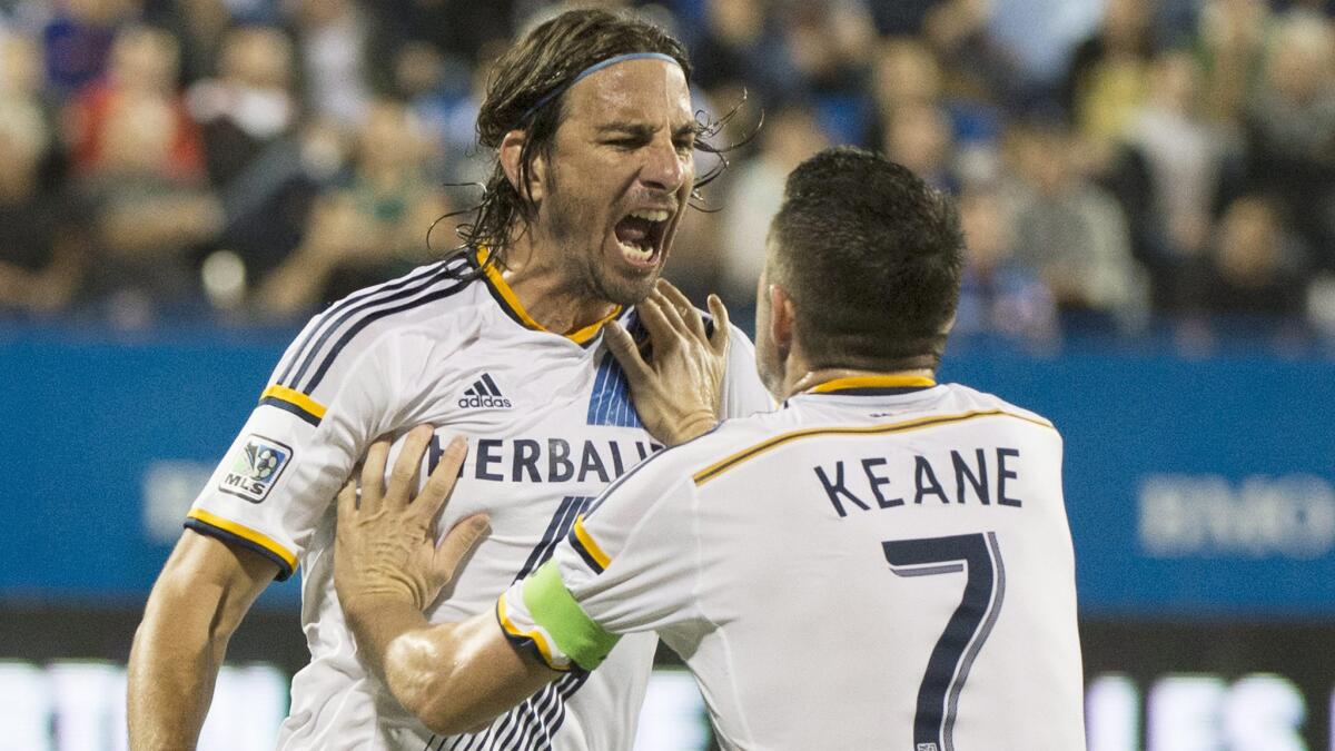 Galaxy forward Alan Gordon's, left, goal in stoppage time gave the Galaxy a 1-0 win over the Houston Dynamo on Friday.