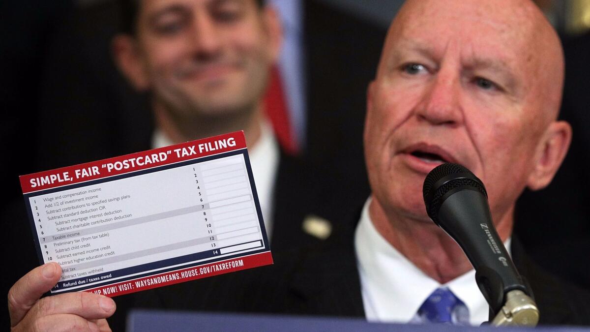 Rep. Kevin Brady (R-Texas) holds up a prop tax-filing postcard during an event on overhauling the tax code on Sept. 27 in Washington.