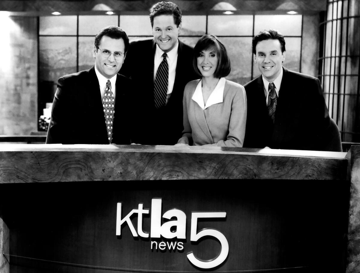 A group of news anchors behind a KTLA 5 desk.